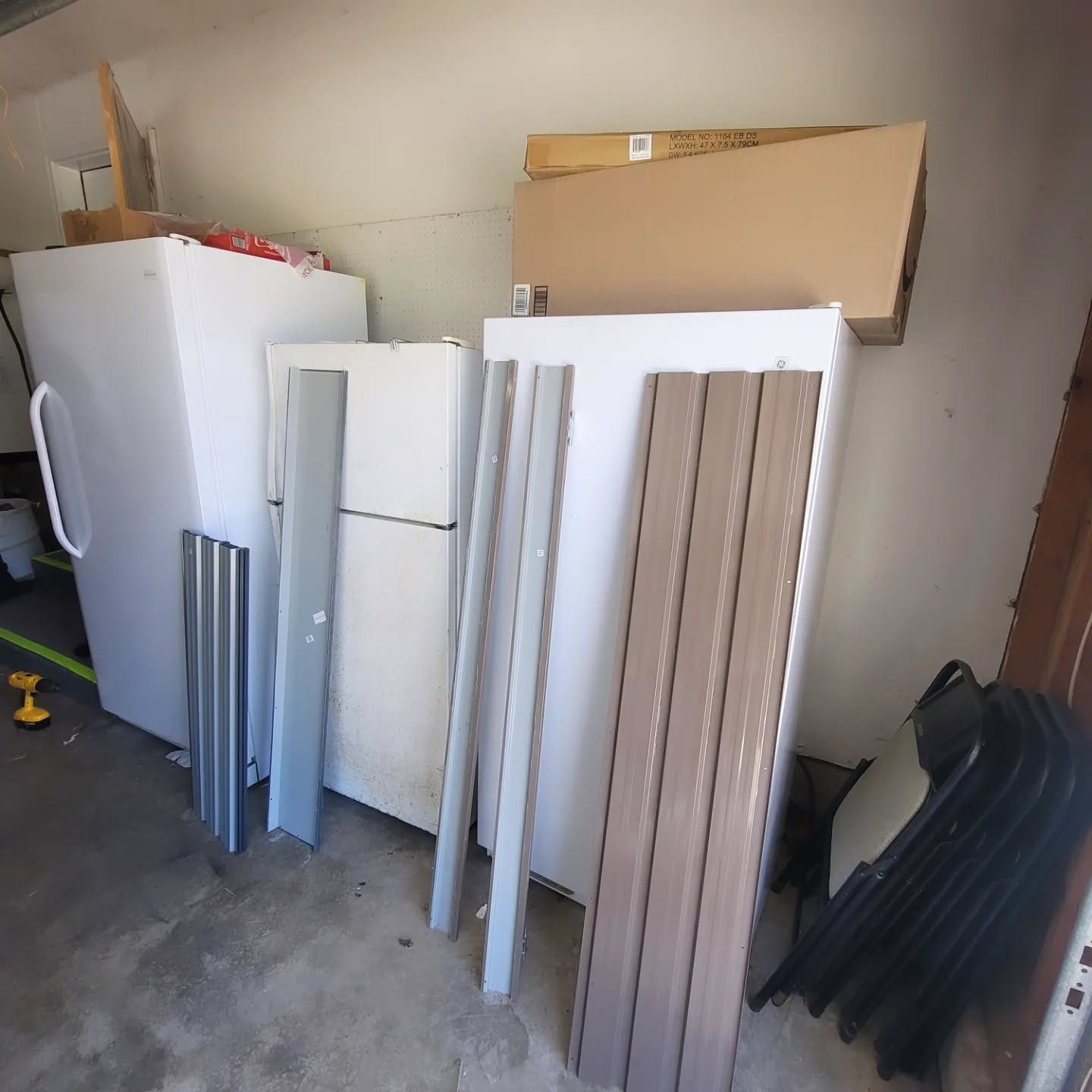 Metal shed pieces laid out before assembly